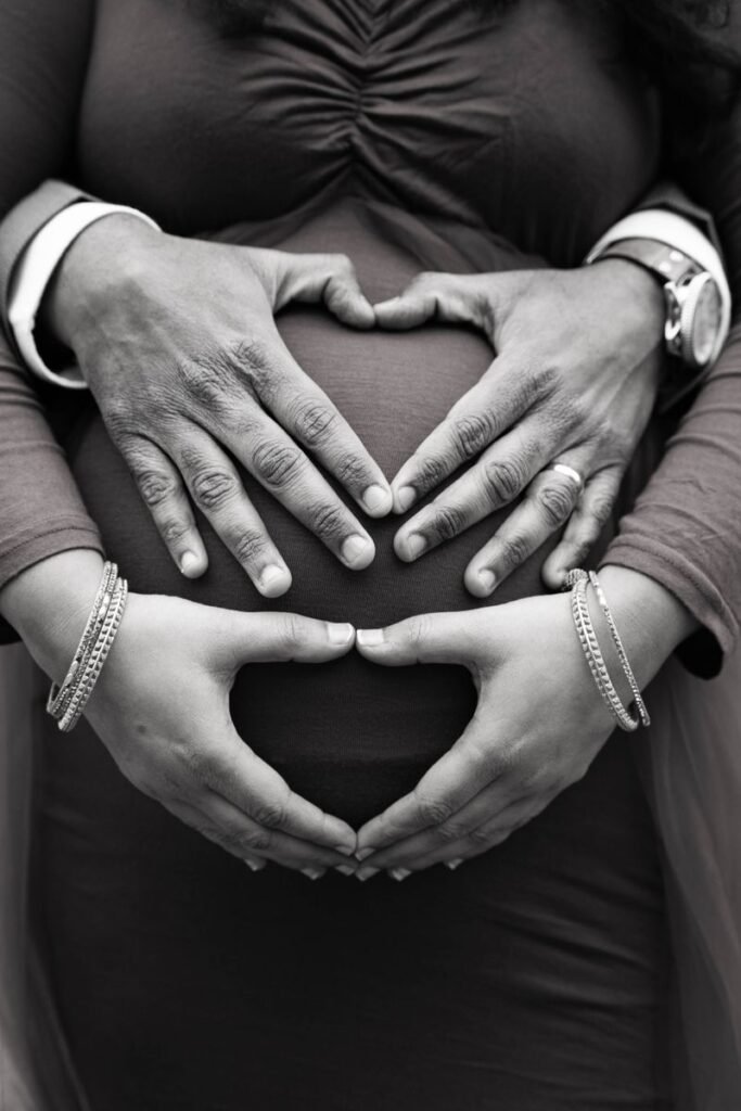 Hands cradling a pregnant belly