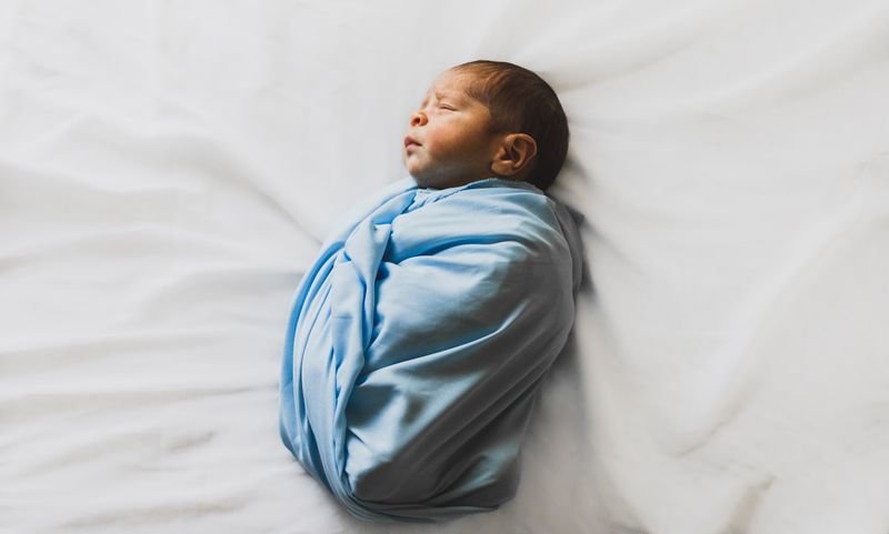 Newborn baby at sunrise representing new life