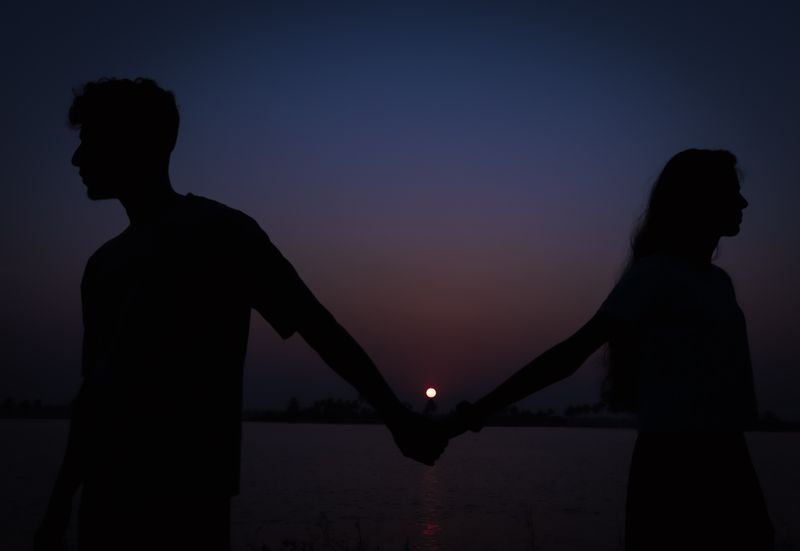 Silhouette of a separated couple at dusk
